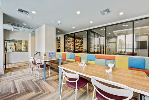 A modern dining area with a wooden table and chairs.