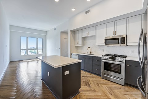 A kitchen with a stove top oven and microwave above it.