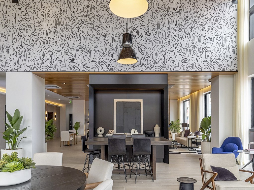 a social lounge with a large table and chairs