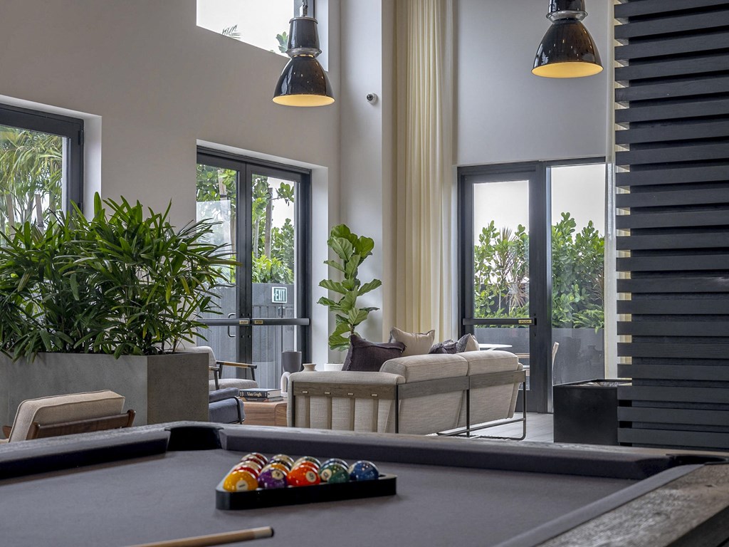 a social lounge filled with furniture and a pool table