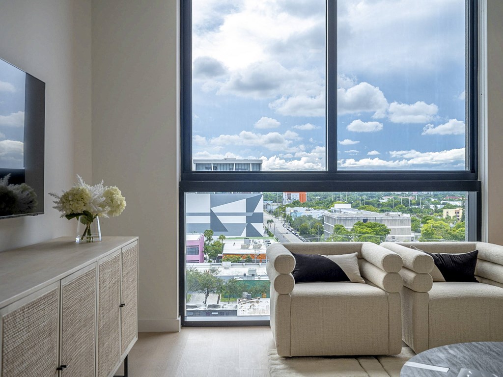 a living room with a view of a city from a window