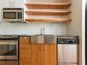 Interiors-Fully Furnished Kitchen With Stainless Steel Appliances Fully Furnished Kitchen With Stainless Steel Appliances at Lower Burnside Lofts, Oregon - Photo Gallery 2