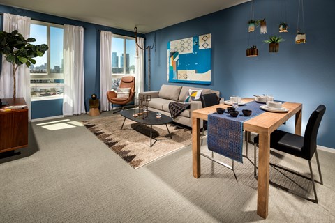 A living room with a brown table and a grey sofa.