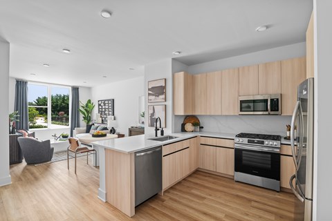 A modern kitchen with wooden cabinets and stainless steel appliances.