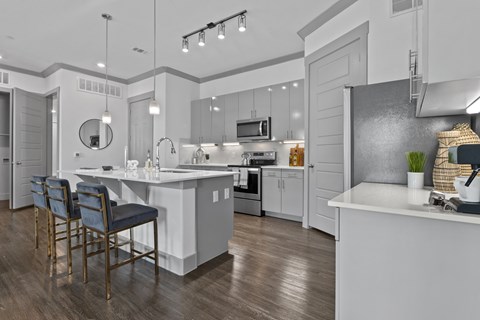 A modern kitchen with a dining table and chairs.