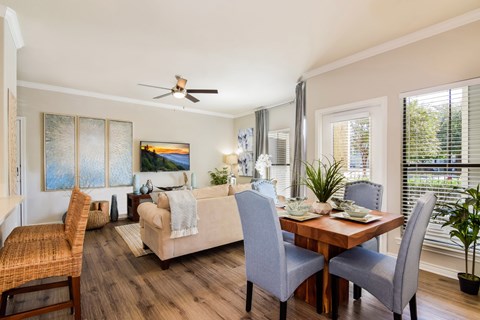 A dining room with a wooden table and grey chairs.
