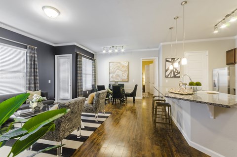 A modern dining room with a wooden table and chairs.
