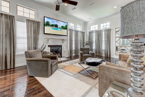 A living room with a fireplace and a television on the wall.