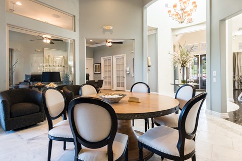 A dining room with a round table and chairs.
