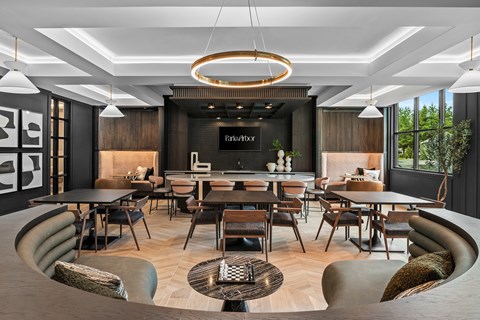 A modern dining room with a large table and chairs.