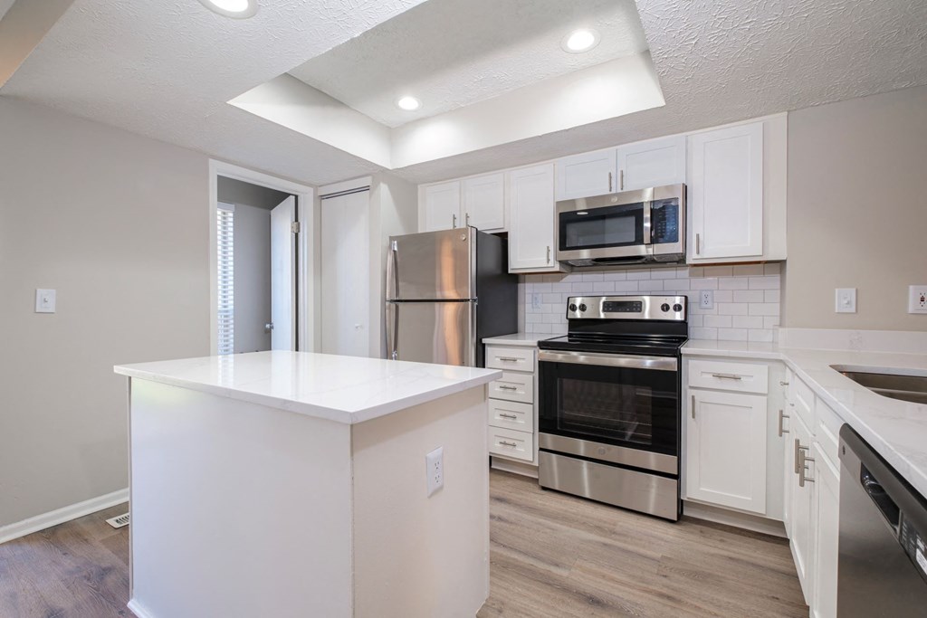 Perimeter Lakes apartments kitchen with white cabinets and stainless appliances