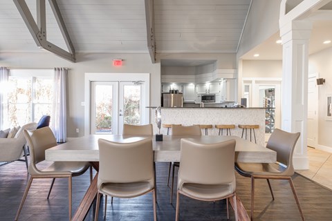 A dining room with a table and chairs.