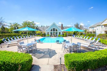 Poolside lounging and swimming pool at Perimeter Lakes apartments