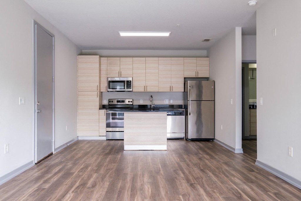 Reveal Heathrow apartments with stainless appliances and wood-inspired flooring