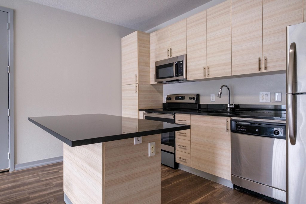 Reveal Heathrow apartment kitchen with sleek quartz countertops and custom cabinetry