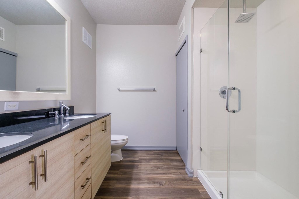 Reveal Heathrow apartments spacious bathroom with  rainshower