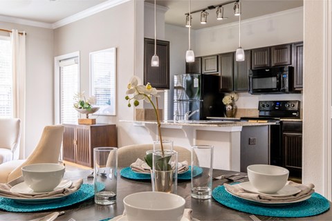 a kitchen and dining room with a table and chairs