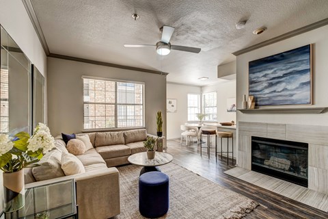 A living room with a fireplace and a painting on the wall.