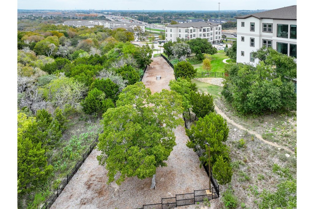 an aerial view of a park with trees and buildings