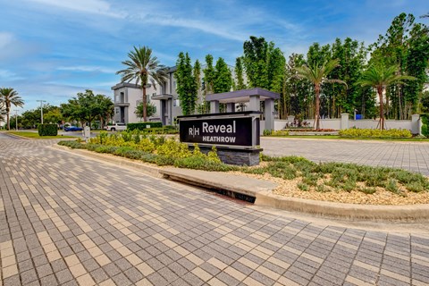 A sign that says RIH Reveal HEATHROW in front of a building.