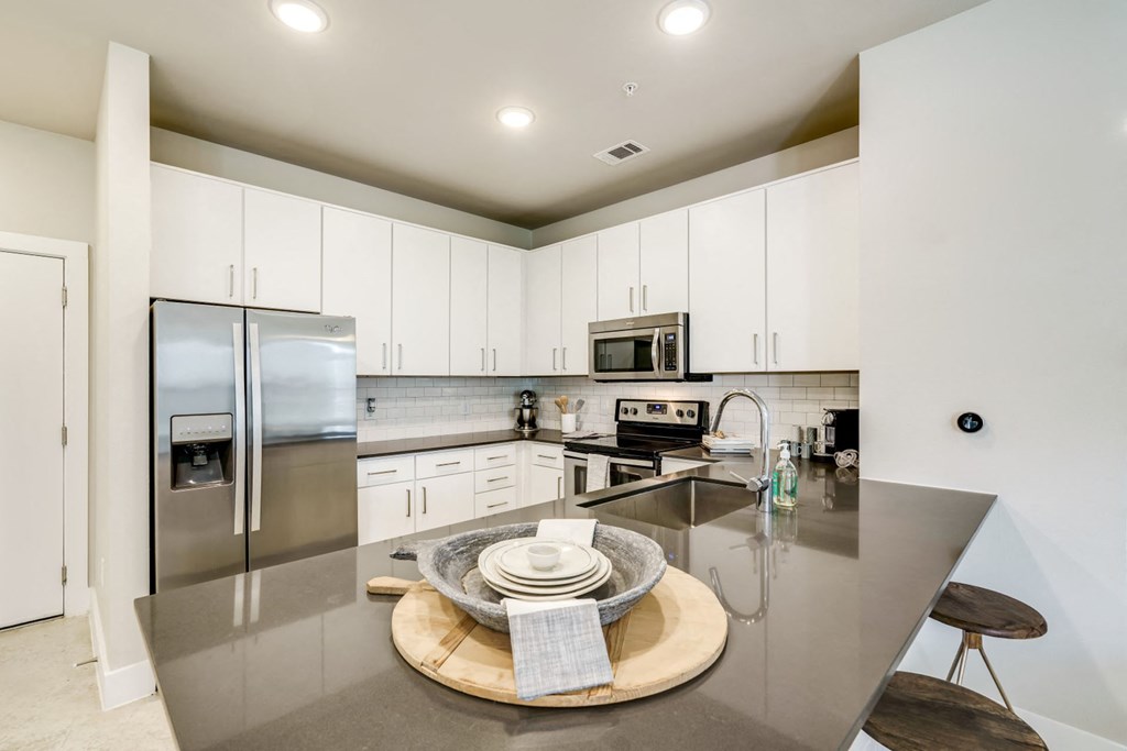 Fitted Kitchen With Island Dining at Berkshire Santal, Austin, Texas