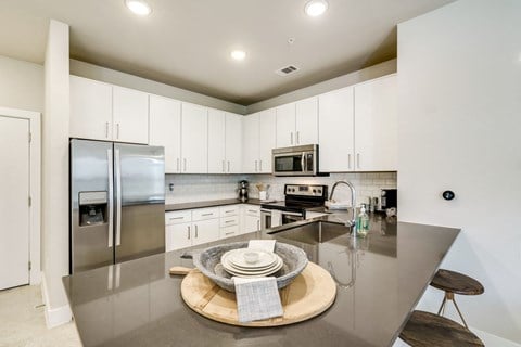 Fitted Kitchen With Island Dining at The Santal, Austin, Texas