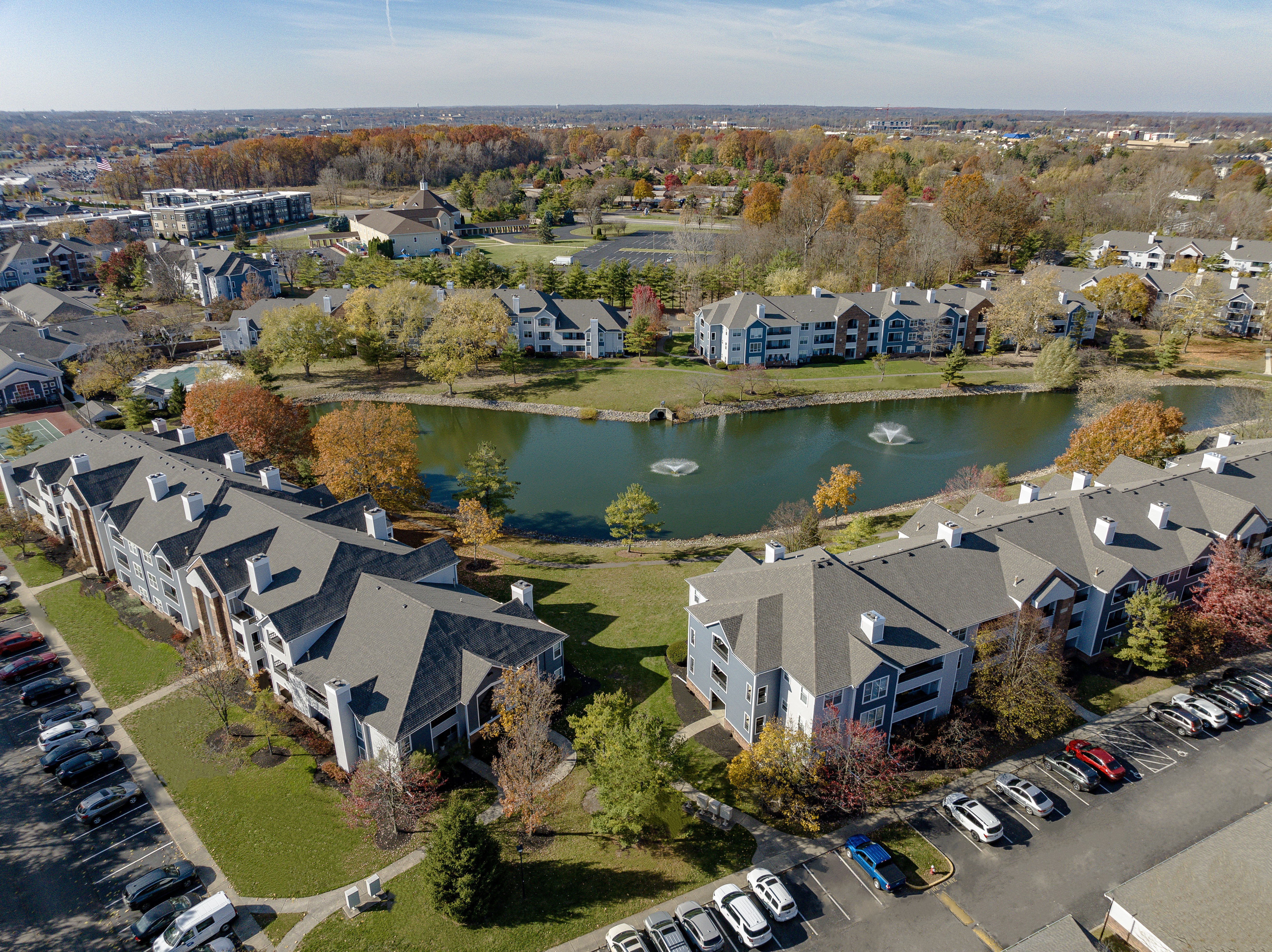 A large building complex with a lake in the middle.
