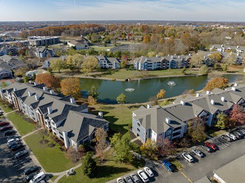 A large building complex with a lake in the middle.