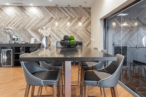 A modern dining room with a large table and chairs.