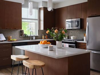 A kitchen with brown cabinets and a white countertop.