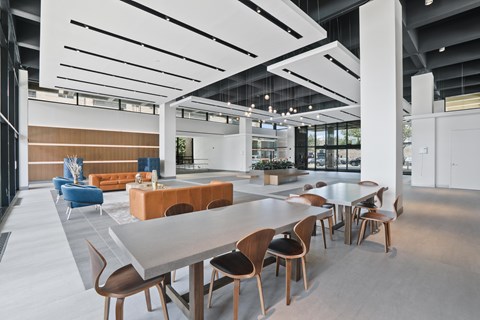 A modern dining area with wooden chairs and tables.