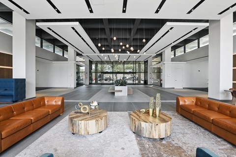 A modern living room with a wooden coffee table in the center.