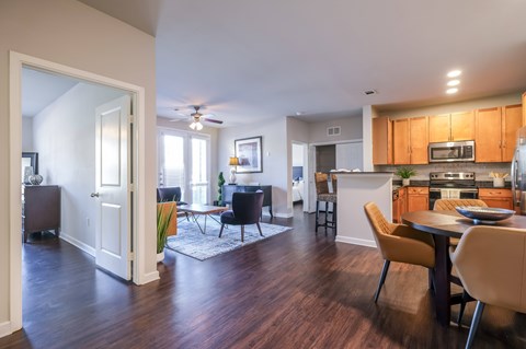 A modern kitchen with a dining table and chairs.