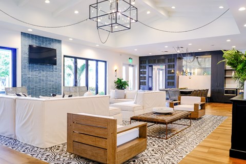 A modern living room with a white sofa and a wooden coffee table.