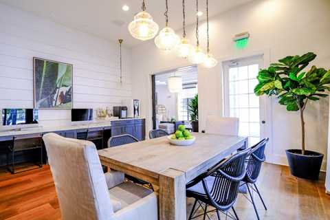 A dining room with a wooden table and chairs.