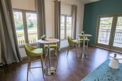 A dining room with a table and chairs.