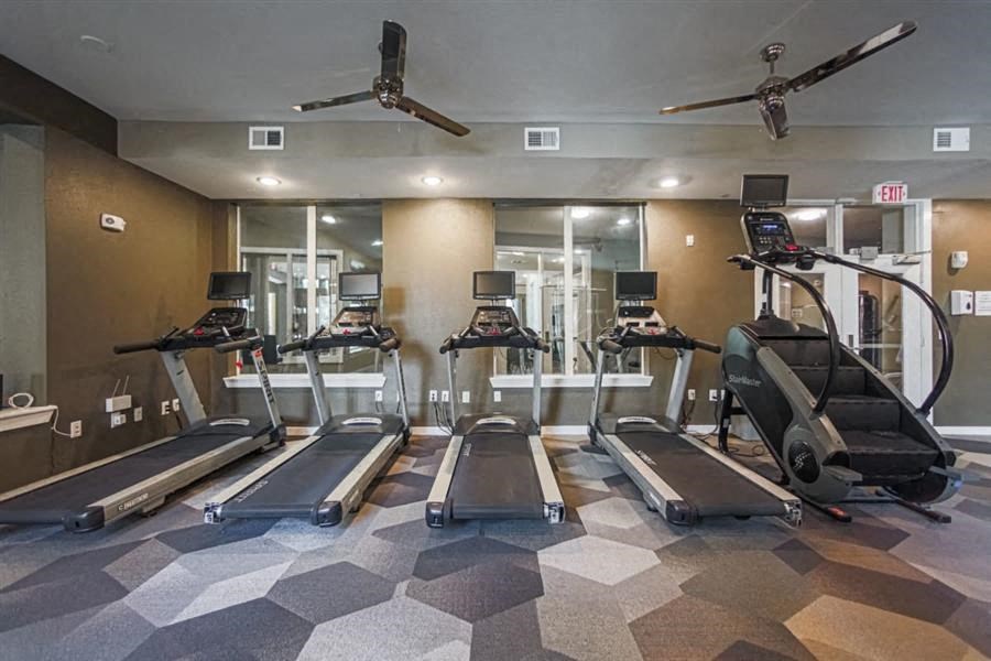 fitness center with cardio equipment at Aspire at 610 apartments