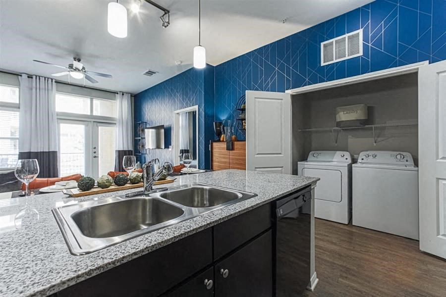 Kitchen with custom cabinetry and granite countertops at Aspire at 610 apartments