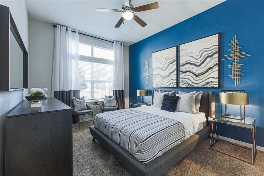 Spacious bedroom with ceiling fan at Aspire at 610 apartments