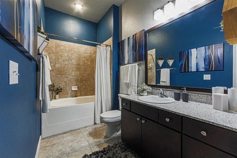Spacious bathroom with soaking tub and tub tile surround at Aspire at 610 apartments