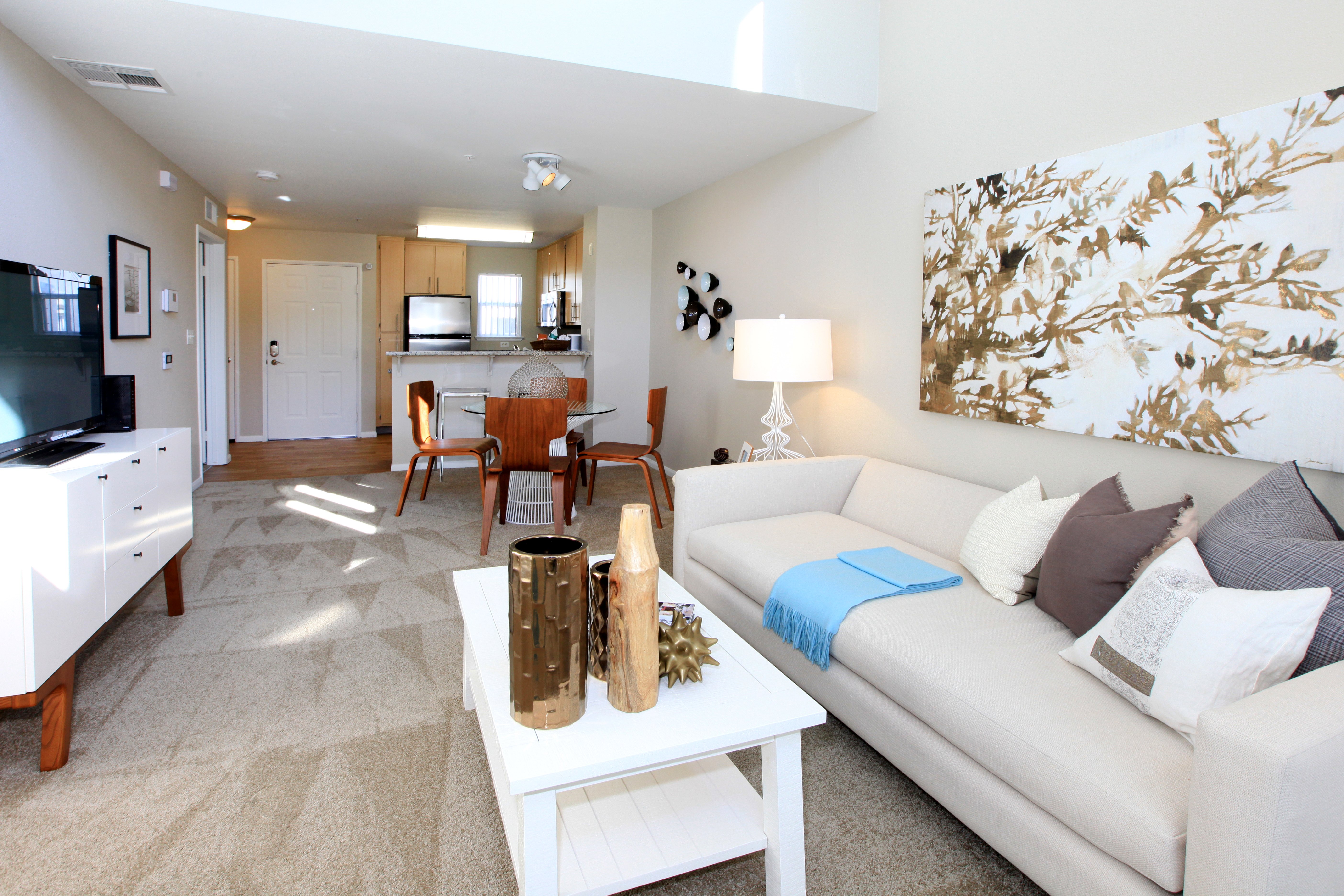 A living room with a white couch and a coffee table.