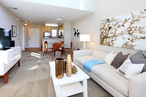 A living room with a white couch and a coffee table.