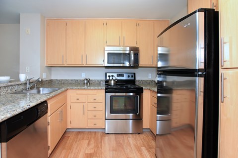 A kitchen with wooden cabinets and stainless steel appliances.
