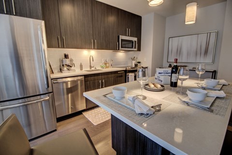 a kitchen with stainless steel appliances and a quartz counter top