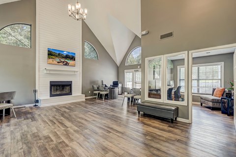 A modern living room with a fireplace and a TV on the wall.