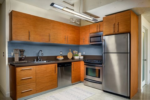 A modern kitchen with wooden cabinets and stainless steel appliances.