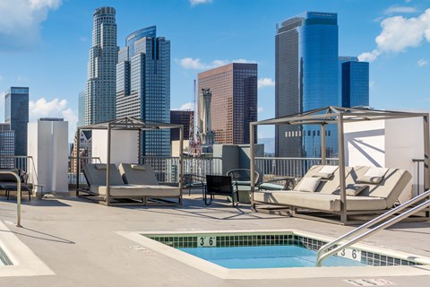 A pool area with a view of the city skyline.