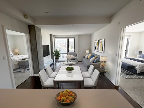 A modern living room with a dining table and chairs.