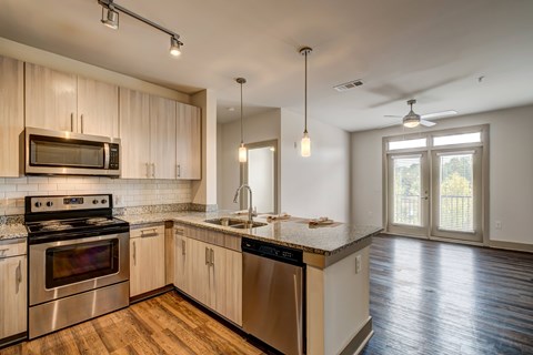 A kitchen with wooden cabinets and stainless steel appliances.