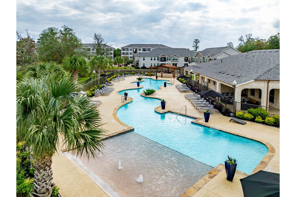 an aerial view of a resort style swimming pool